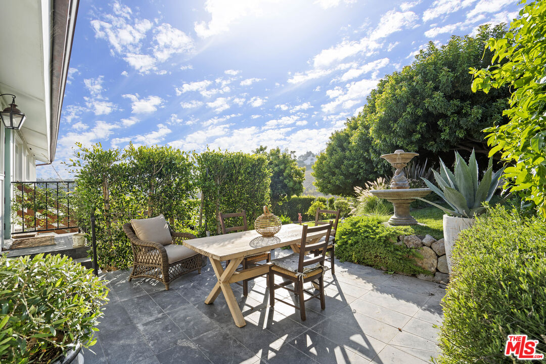 6363 Zumirez Drive Malibu, CA 90265 - Photo 13 of 34 a view of a patio with table and chairs and potted plants