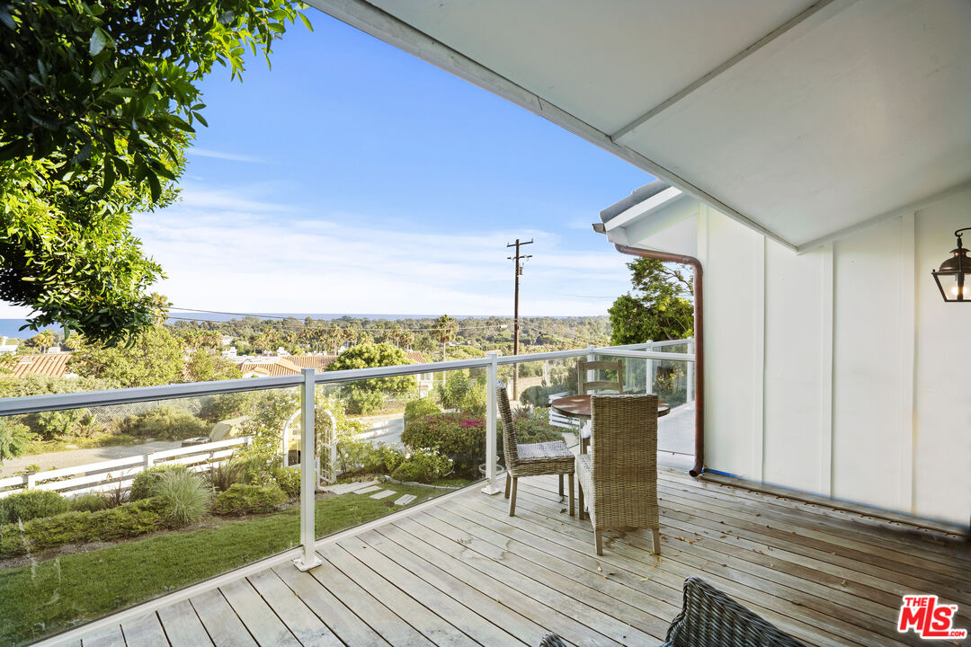 6363 Zumirez Drive Malibu, CA 90265 - Photo 15 of 34 a view of a balcony with chair and wooden floor