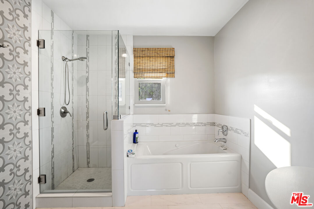 6363 Zumirez Drive Malibu, CA 90265 - Photo 17 of 34 a bathroom with a bathtub and a shower