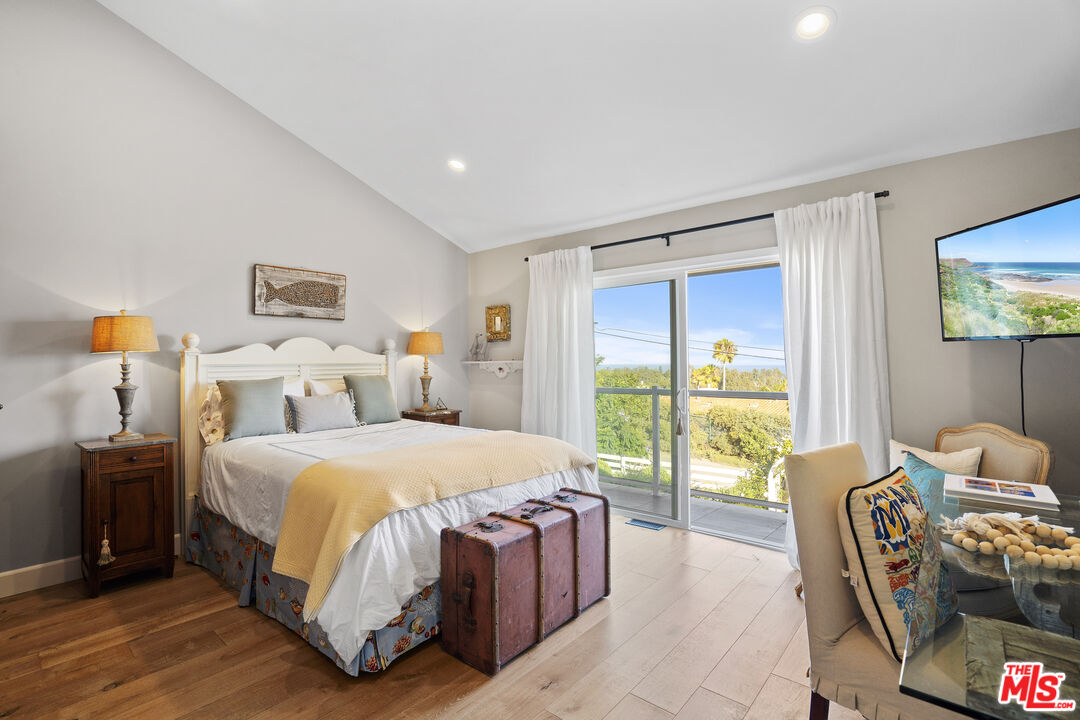 6363 Zumirez Drive Malibu, CA 90265 - Photo 18 of 34 a bedroom with a bed and a window