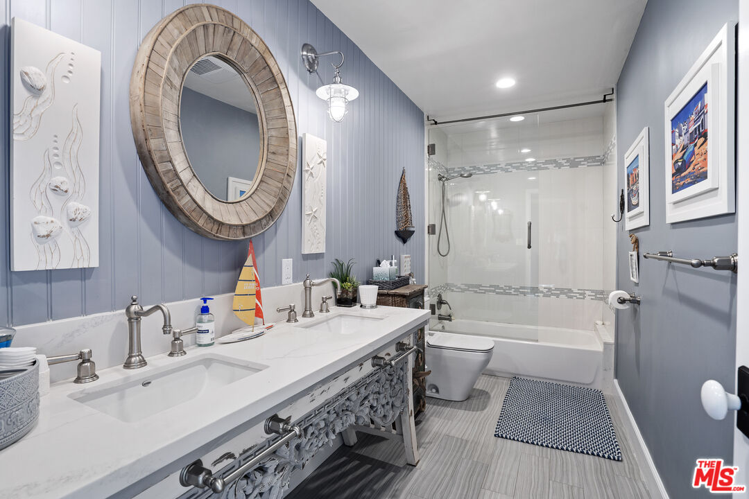 6363 Zumirez Drive Malibu, CA 90265 - Photo 21 of 34 a bathroom with a double vanity sink toilet mirror and bathtub