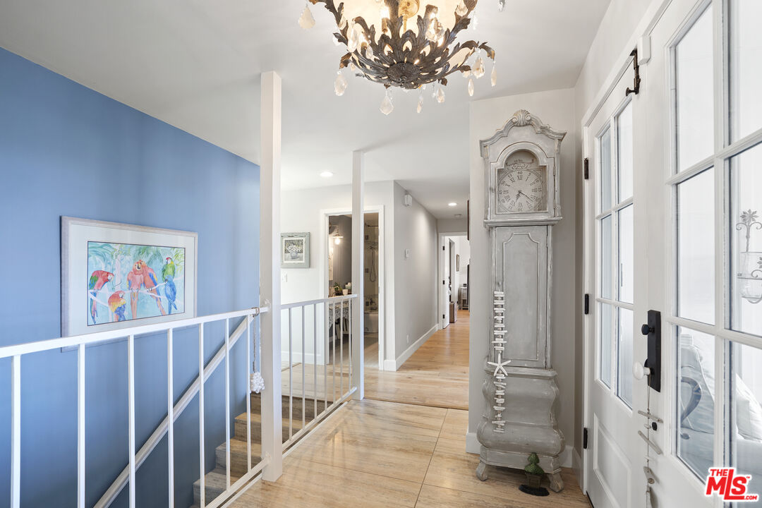 6363 Zumirez Drive Malibu, CA 90265 - Photo 22 of 34 a view of a hallway with wooden floor and front door