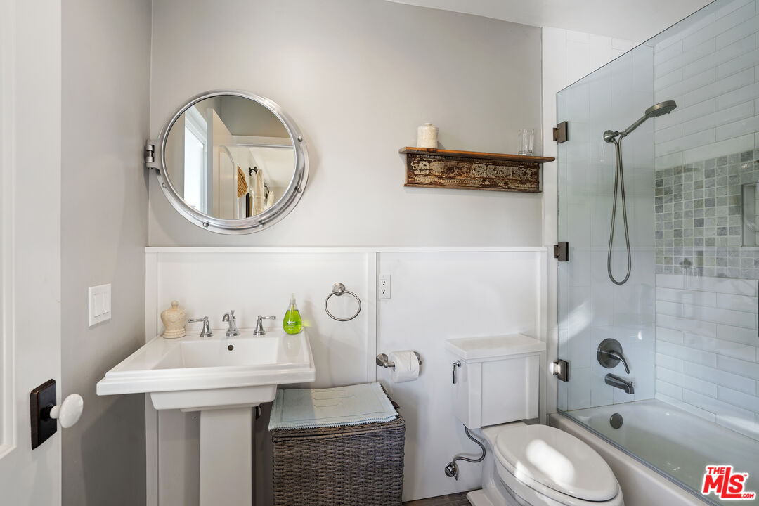 6363 Zumirez Drive Malibu, CA 90265 - Photo 24 of 34 a bathroom with a sink a toilet and a mirror