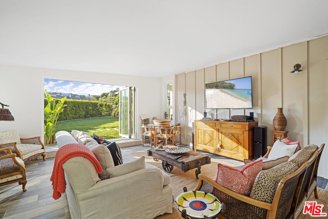 6363 Zumirez Drive Malibu, CA 90265 - Photo 25 of 34 a living room with furniture and a large window