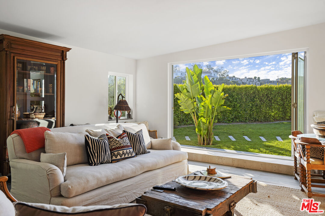 6363 Zumirez Drive Malibu, CA 90265 - Photo 26 of 34 a living room with furniture and a large window
