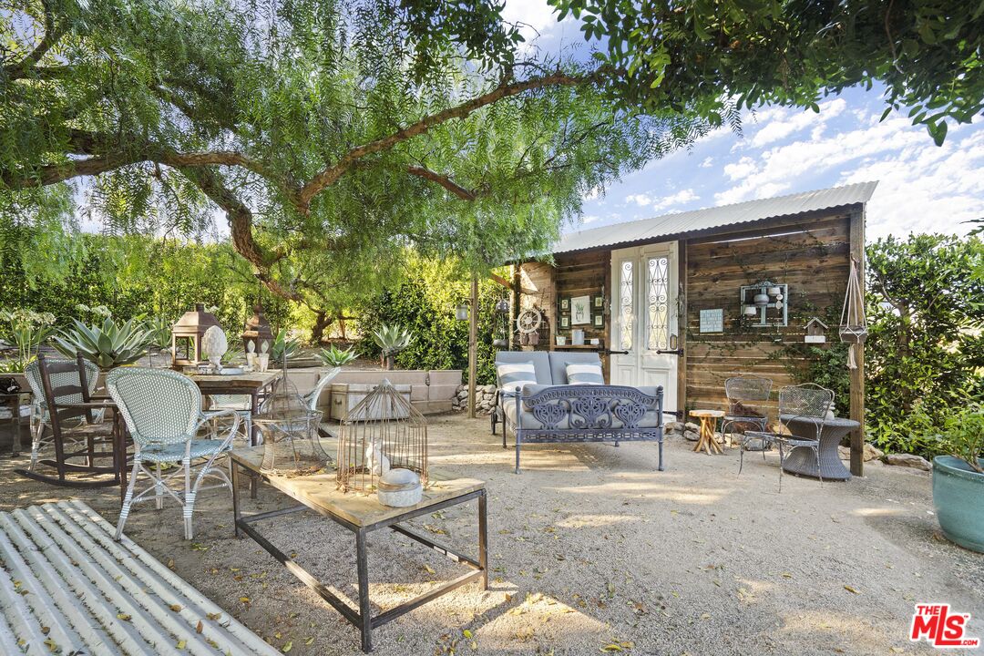 6363 Zumirez Drive Malibu, CA 90265 - Photo 30 of 34 a view of a patio with table and chairs and potted plants