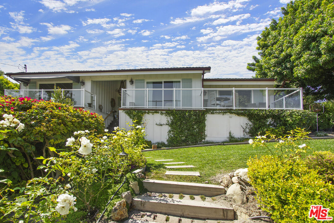 6363 Zumirez Drive Malibu, CA 90265 - Photo 4 of 34 a front view of house with yard and green space