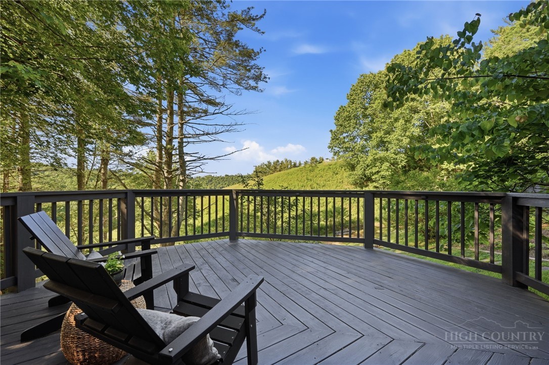 165 All Hallows Road Boone, NC 28607 - Photo 24 of 50 a view of a wooden deck with a bench
