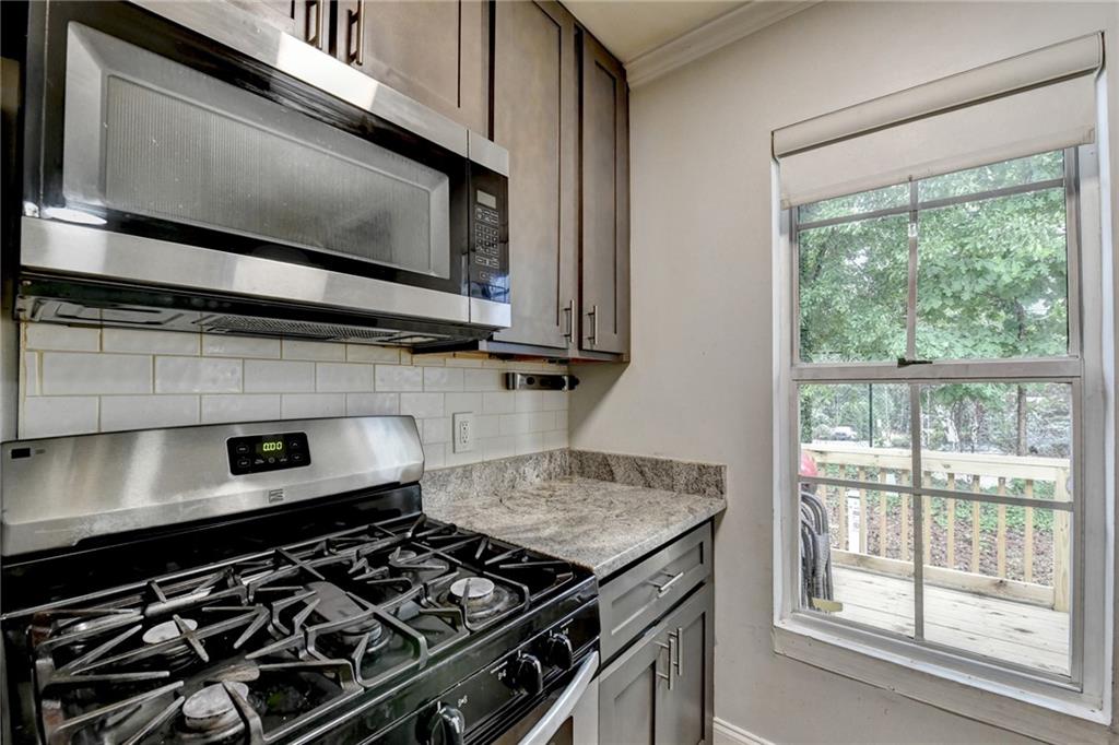 3400 Spring Harbor Drive Doraville, GA 30340 - Photo 16 of 33 a kitchen with a stove and a microwave
