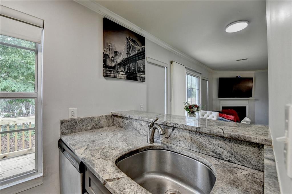 3400 Spring Harbor Drive Doraville, GA 30340 - Photo 18 of 33 a bathroom with a granite countertop sink a mirror and a window