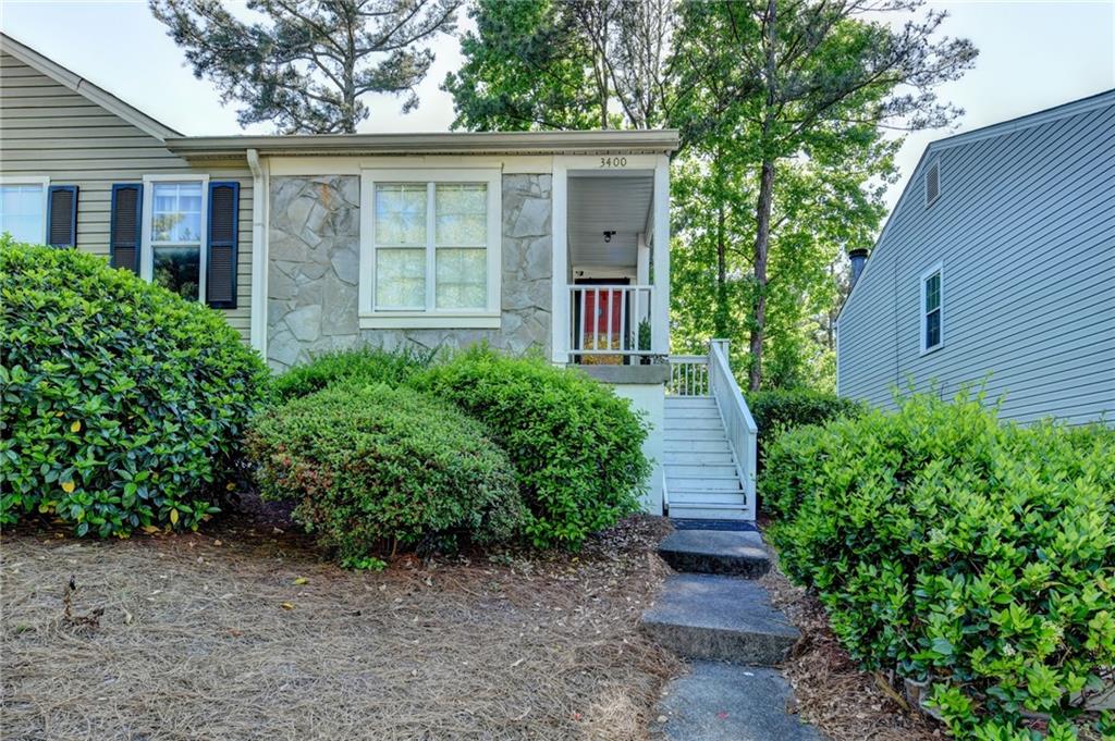 3400 Spring Harbor Drive Doraville, GA 30340 - Photo 2 of 33 a front view of a house with a yard and trees