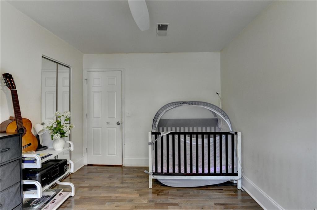 3400 Spring Harbor Drive Doraville, GA 30340 - Photo 26 of 33 an empty room with wooden floor and a potted plant