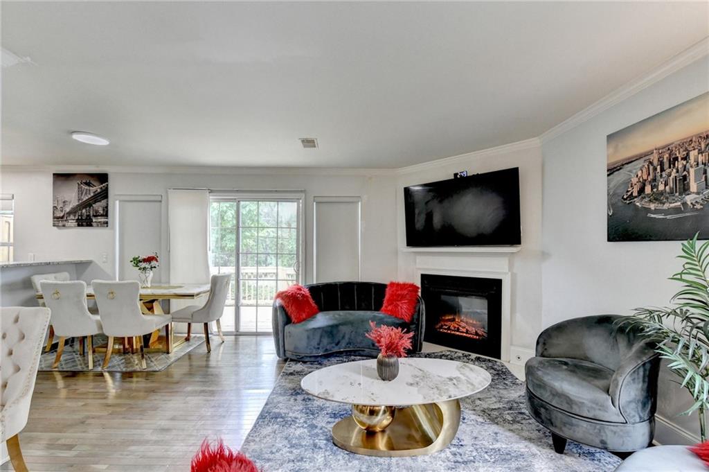 3400 Spring Harbor Drive Doraville, GA 30340 - Photo 6 of 33 a living room with furniture a flat screen tv and a fireplace