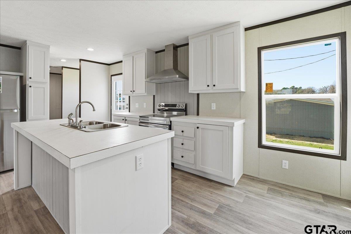 8886 Bayberry Road Gilmer, TX 75645 - Photo 11 of 24 a kitchen with a sink cabinets and wooden floor