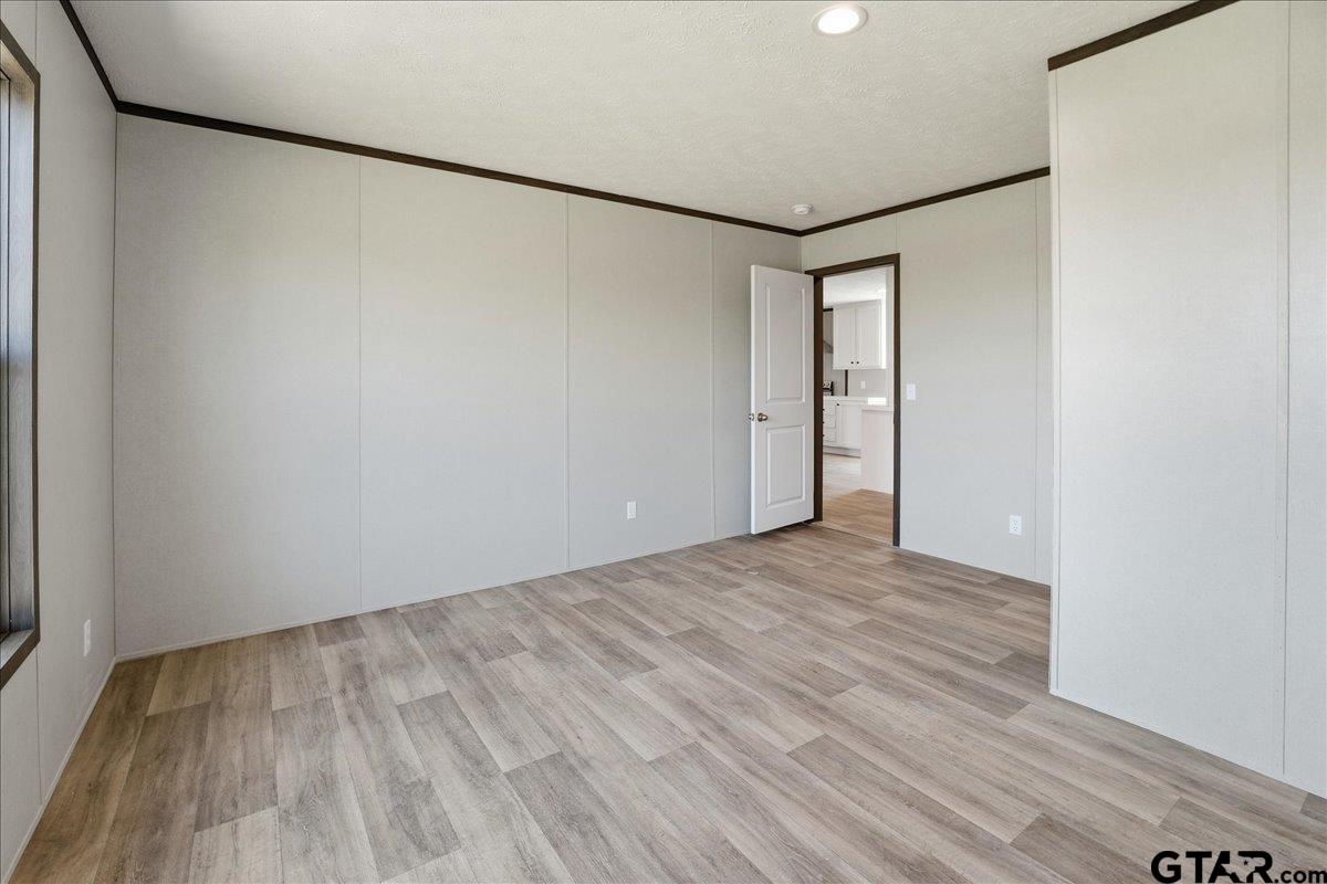 8886 Bayberry Road Gilmer, TX 75645 - Photo 16 of 24 a view of empty room with wooden floor