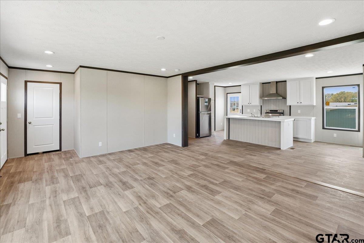 8886 Bayberry Road Gilmer, TX 75645 - Photo 18 of 24 a view of empty room with kitchen and window