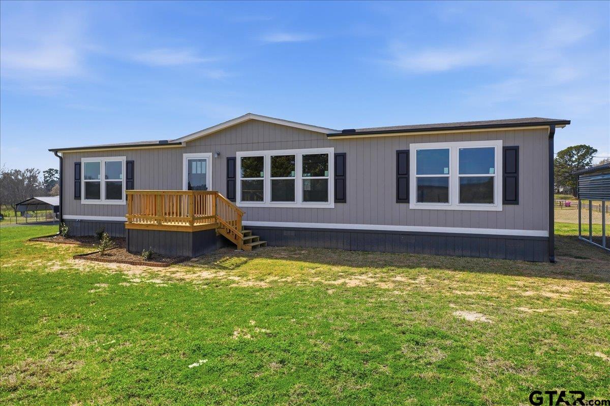8886 Bayberry Road Gilmer, TX 75645 - Photo 2 of 24 a view of a house with a yard patio and a swimming pool
