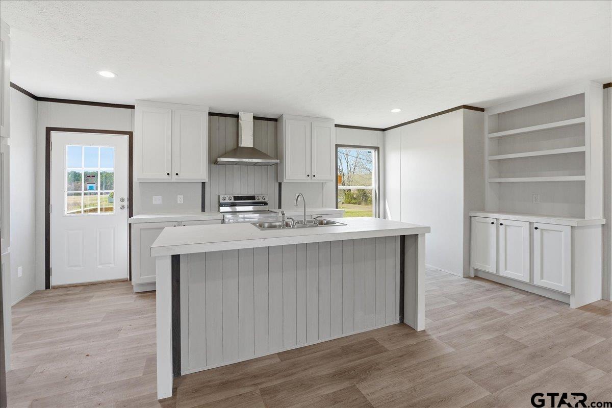 8886 Bayberry Road Gilmer, TX 75645 - Photo 21 of 24 a kitchen with stainless steel appliances a sink cabinets and wooden floor