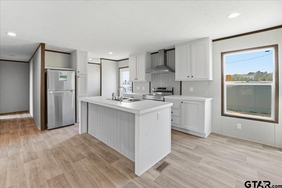 8886 Bayberry Road Gilmer, TX 75645 - Photo 22 of 24 a kitchen with white cabinets and white appliances