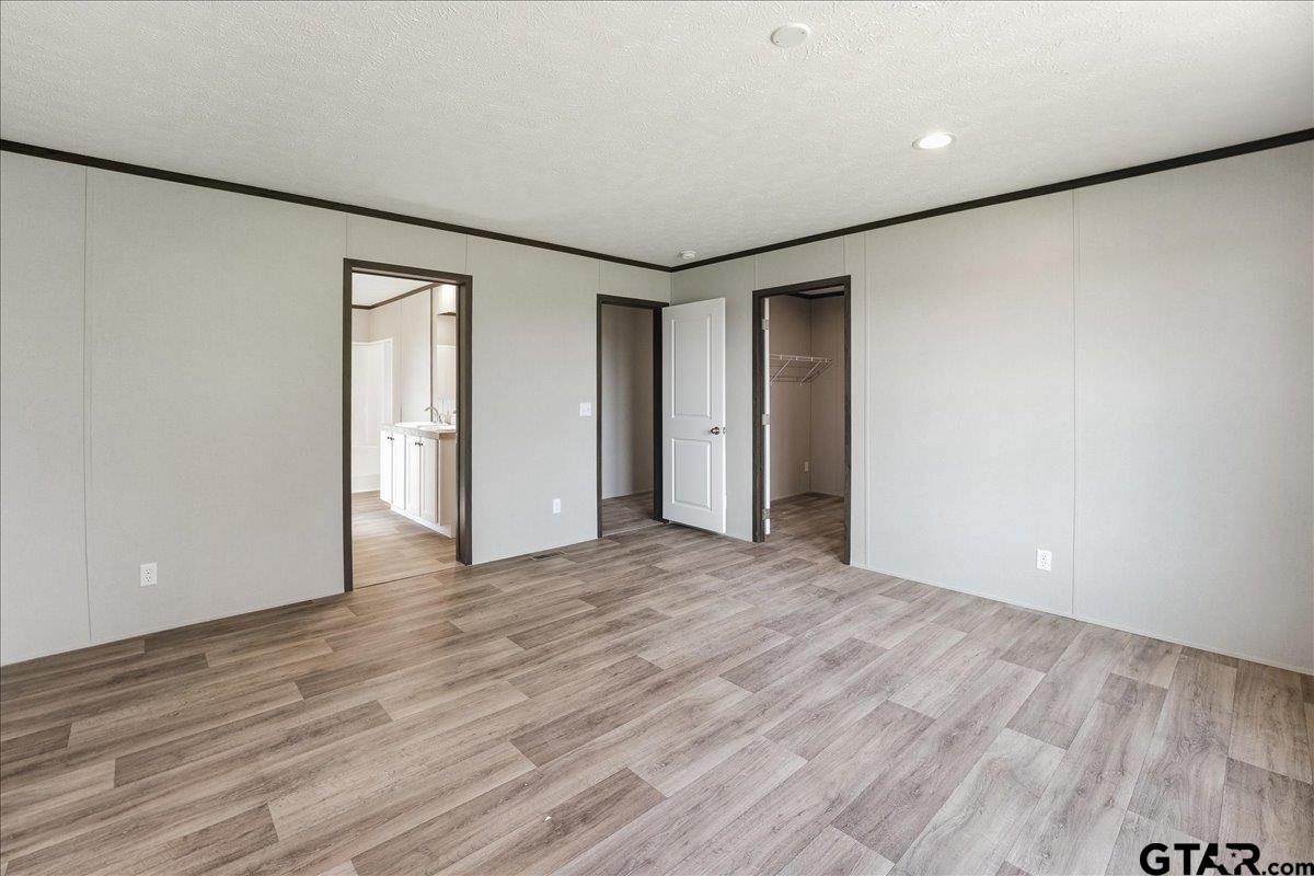 8886 Bayberry Road Gilmer, TX 75645 - Photo 24 of 24 a view of an empty room with wooden floor