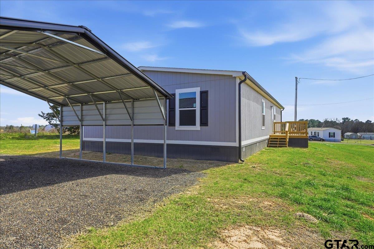 8886 Bayberry Road Gilmer, TX 75645 - Photo 4 of 24 a backyard of a house with a small yard and wooden fence