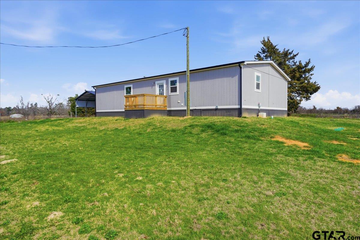 8886 Bayberry Road Gilmer, TX 75645 - Photo 5 of 24 a house view with a garden space