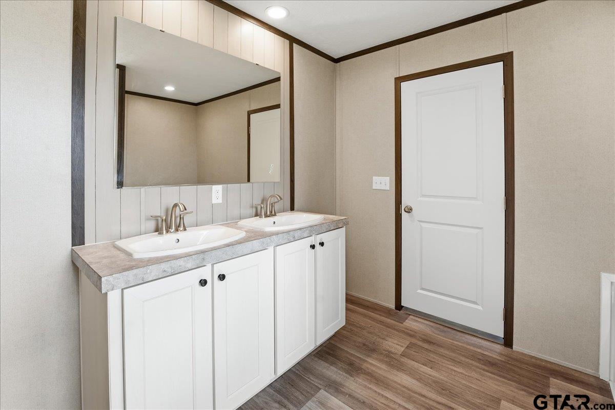 8886 Bayberry Road Gilmer, TX 75645 - Photo 7 of 24 a bathroom with a sink a mirror and a shower
