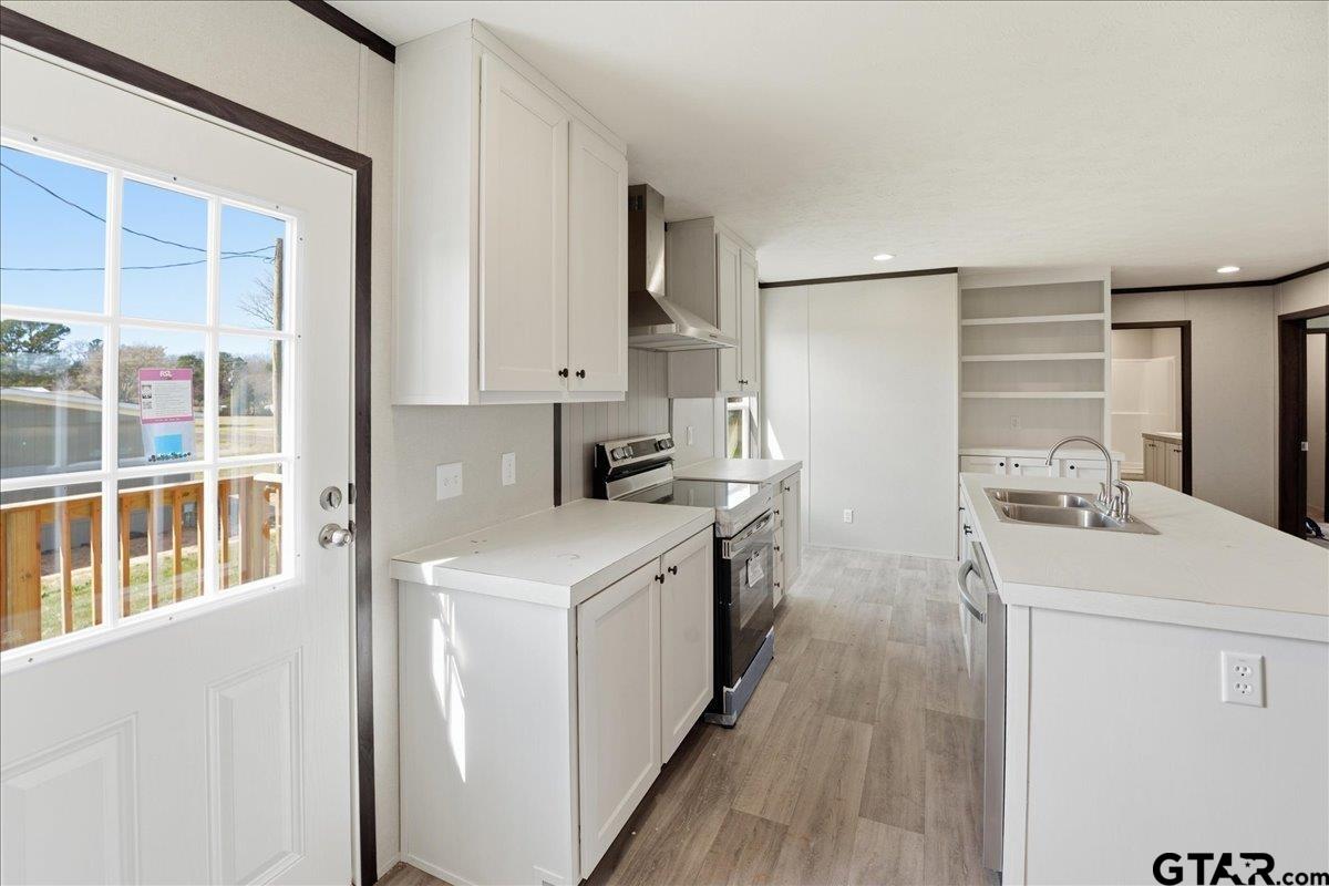 8886 Bayberry Road Gilmer, TX 75645 - Photo 9 of 24 a kitchen with a sink stove and refrigerator