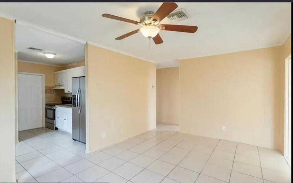 808 West 4th Street Riviera Beach, FL 33404 - Photo 7 of 10 a view of a kitchen with a sink and a refrigerator