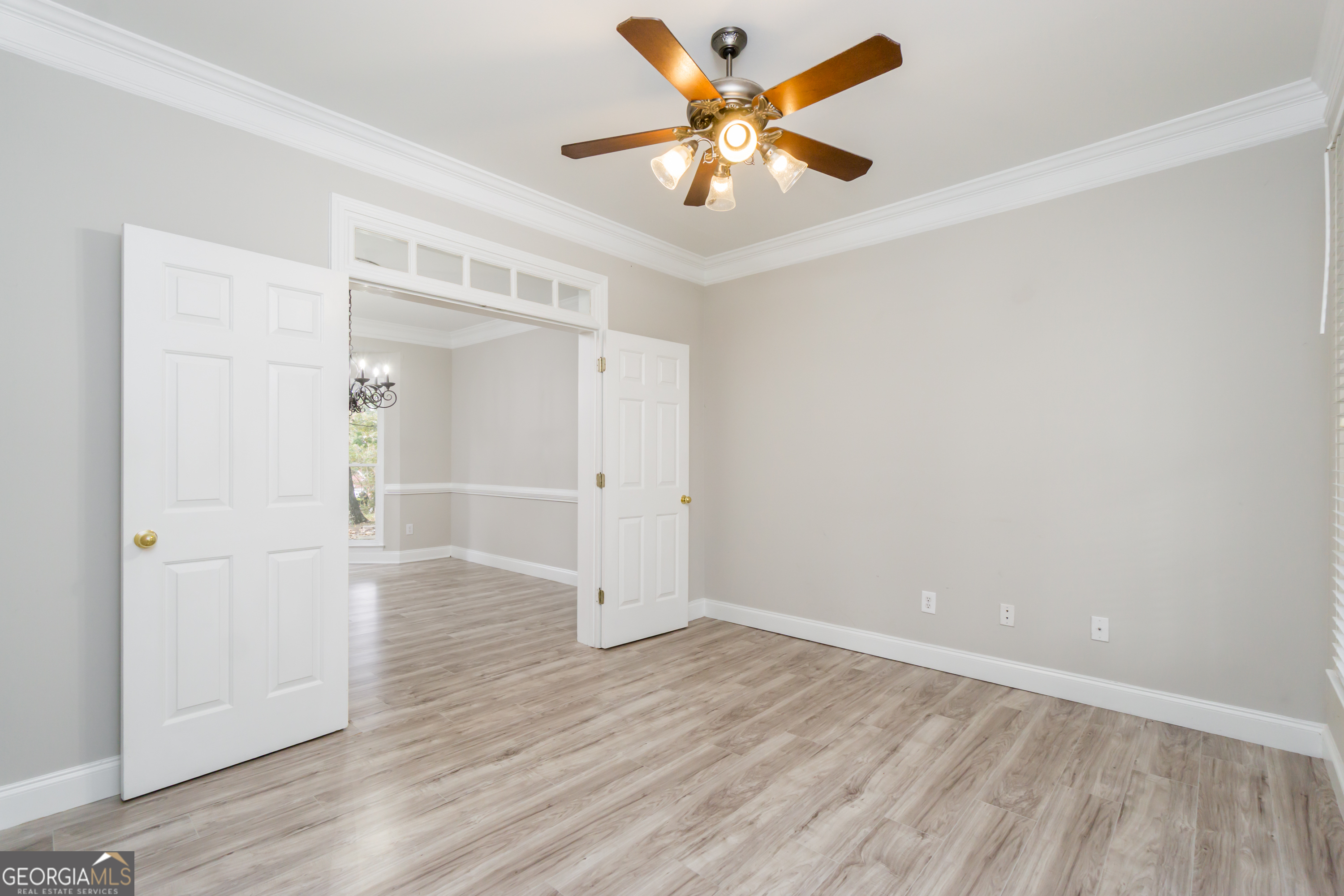 6710 Timber Cove Pointe Cumming, GA 30041 - Photo 13 of 51 an empty room with wooden floor and a ceiling fan