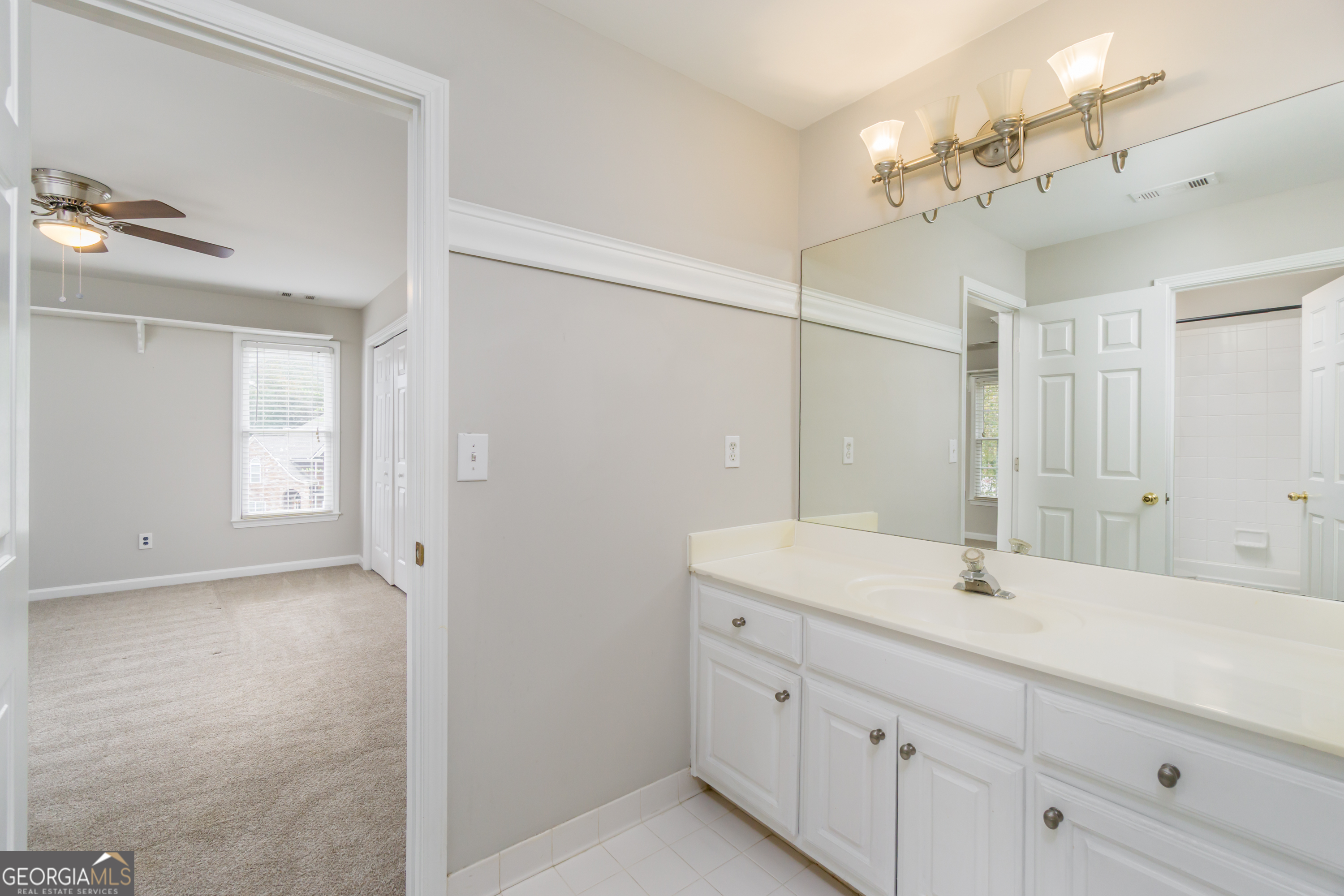 6710 Timber Cove Pointe Cumming, GA 30041 - Photo 32 of 51 a bathroom with a sink a light fixture a vanity and a mirror