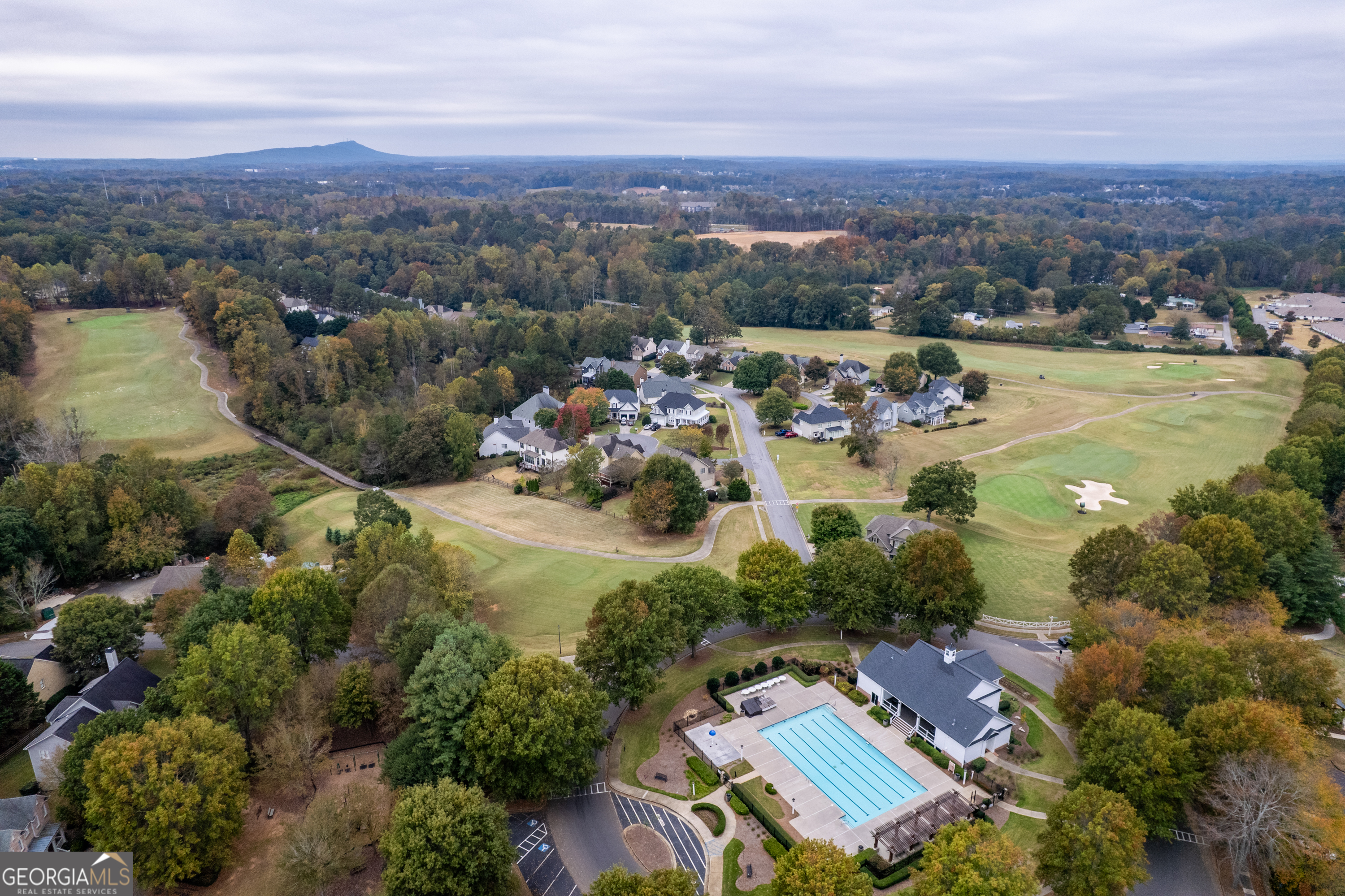 6710 Timber Cove Pointe Cumming, GA 30041 - Photo 48 of 51 an aerial view of a city with lots of residential buildings and mountain view in back