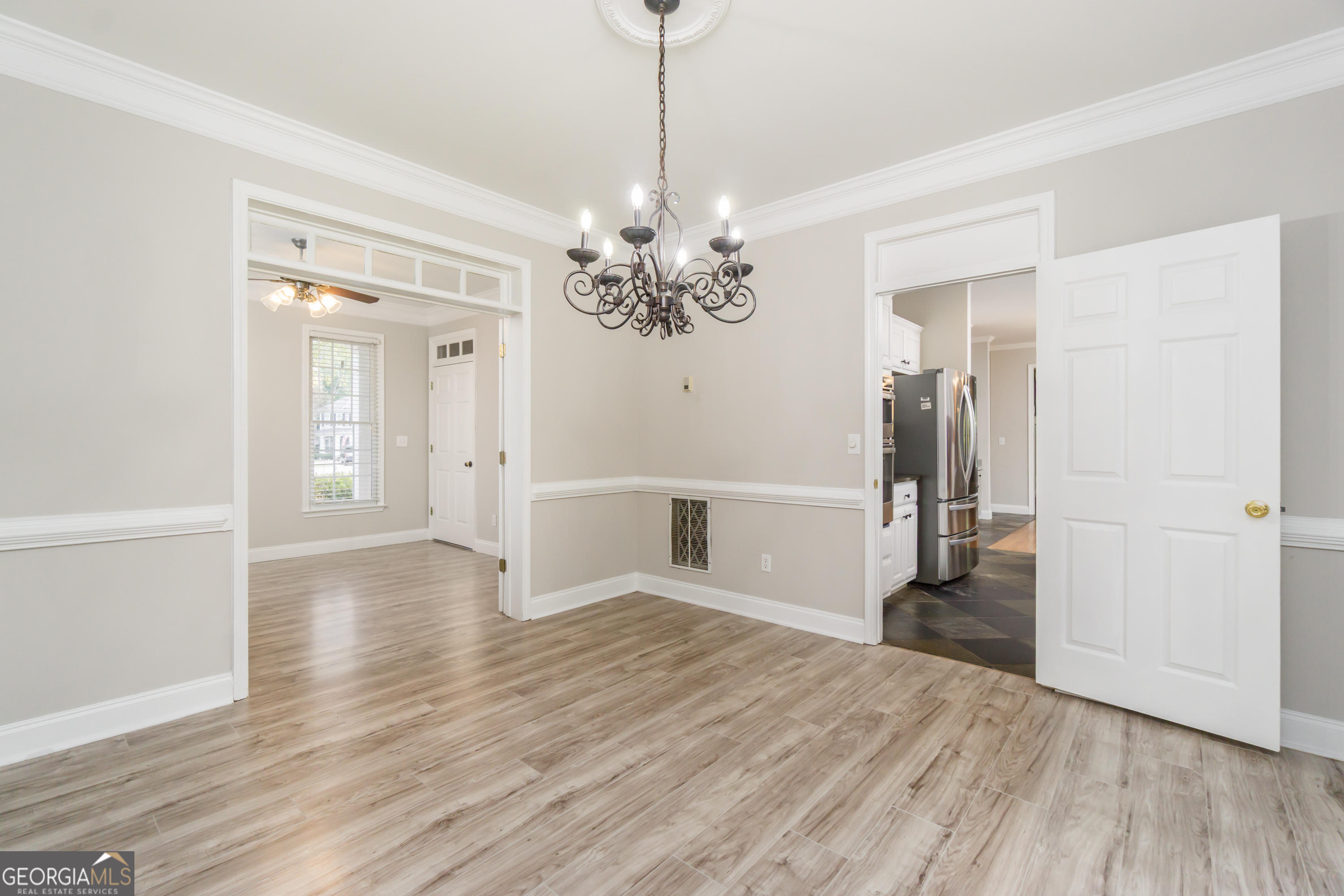6710 Timber Cove Pointe Cumming, GA 30041 - Photo 10 of 51 a view of a hallway with wooden floor and a chandelier
