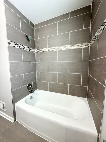 a bathroom with a bathtub and shower