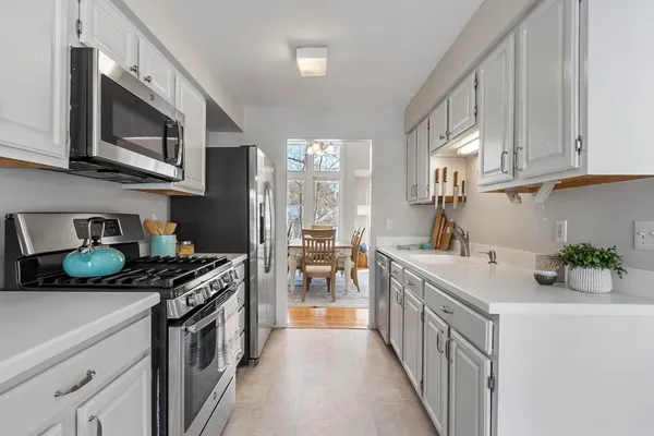 a kitchen with stainless steel appliances granite countertop a sink and a stove
