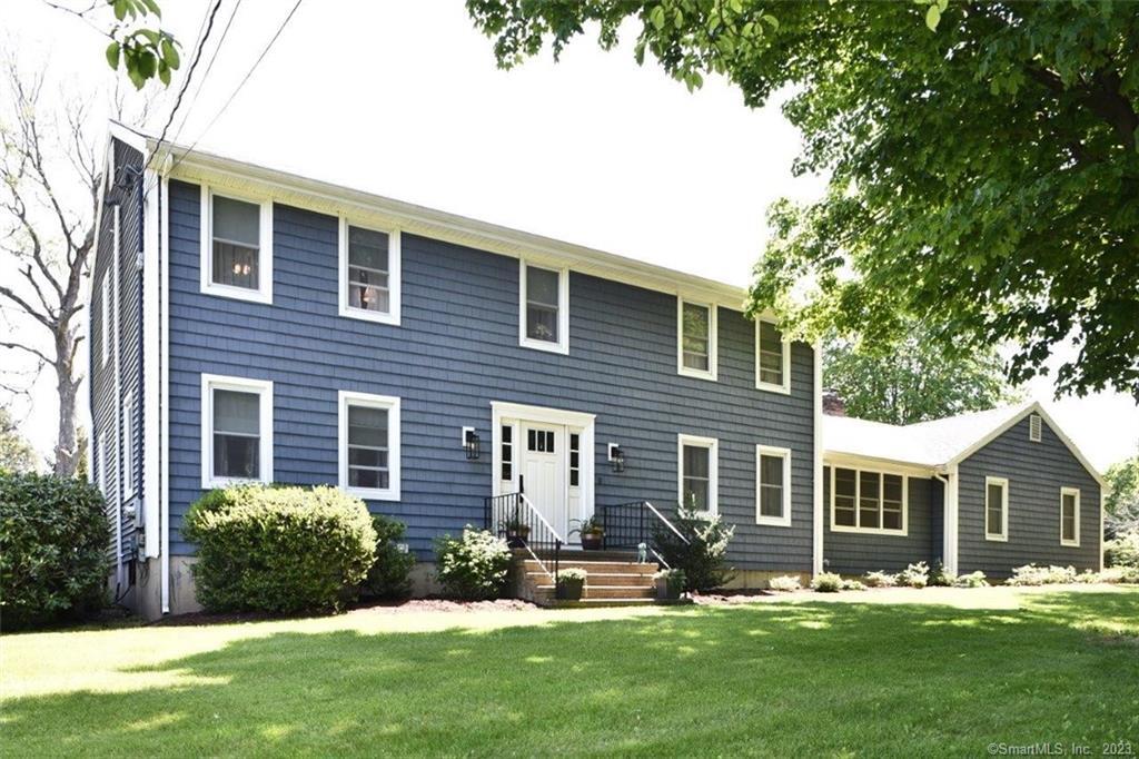 7 Unity Drive Trumbull, CT 06611 - Photo 1 of 1 a front view of a house with a yard and trees