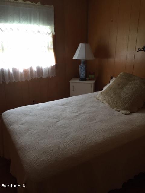 71 South Sandisfield Road Sandisfield, MA 01255 - Photo 14 of 22 a bed room with a bed and a night stand