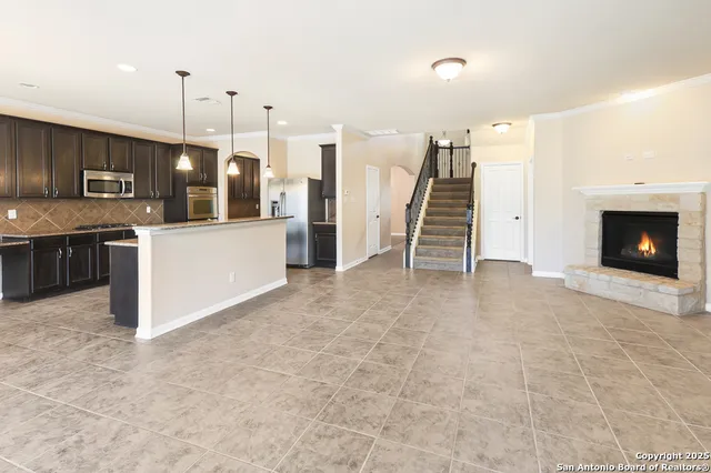a view of a kitchen with furniture and a fireplace