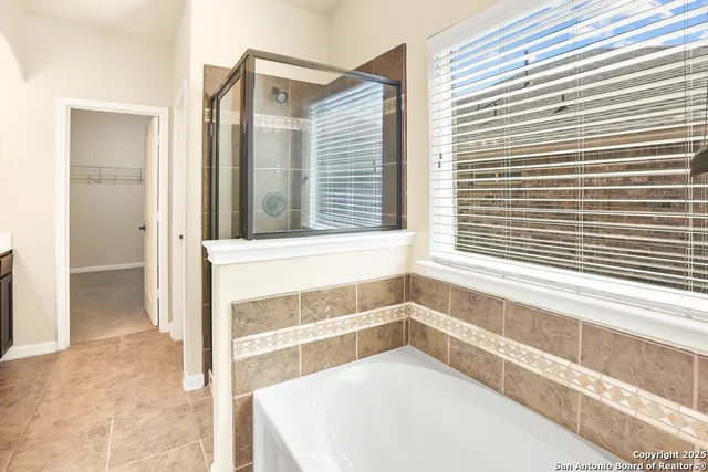 a bathroom with a tub and a window