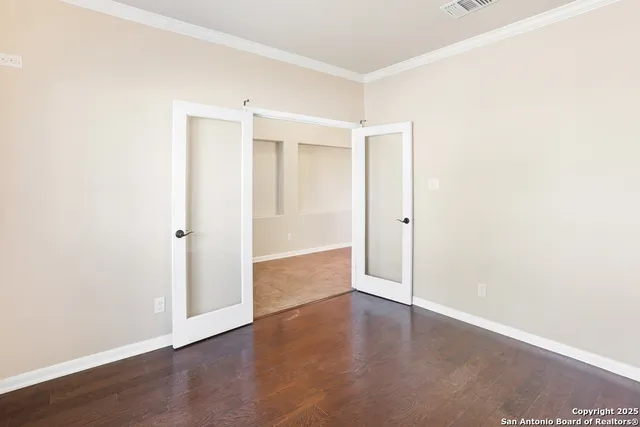 an empty room with wooden floor