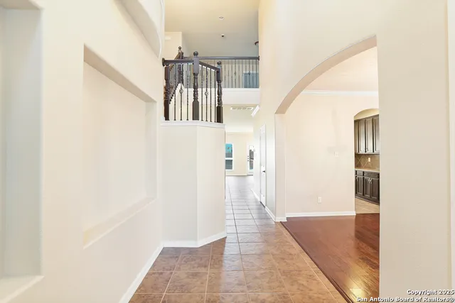 a view of a hallway with a white walls and stairs