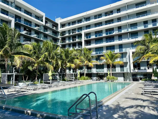 a building view with swimming pool and glass windows
