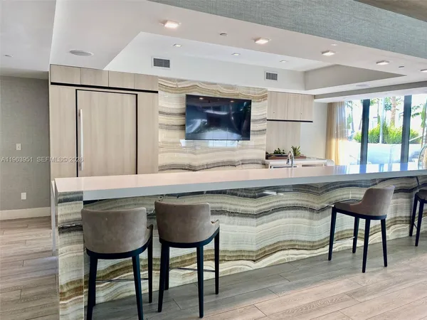 a kitchen with a table chairs refrigerator and cabinets
