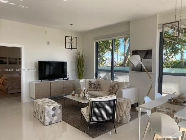 a living room with furniture fireplace and a flat screen tv