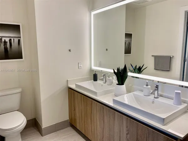 a bathroom with a sink toilet and mirror