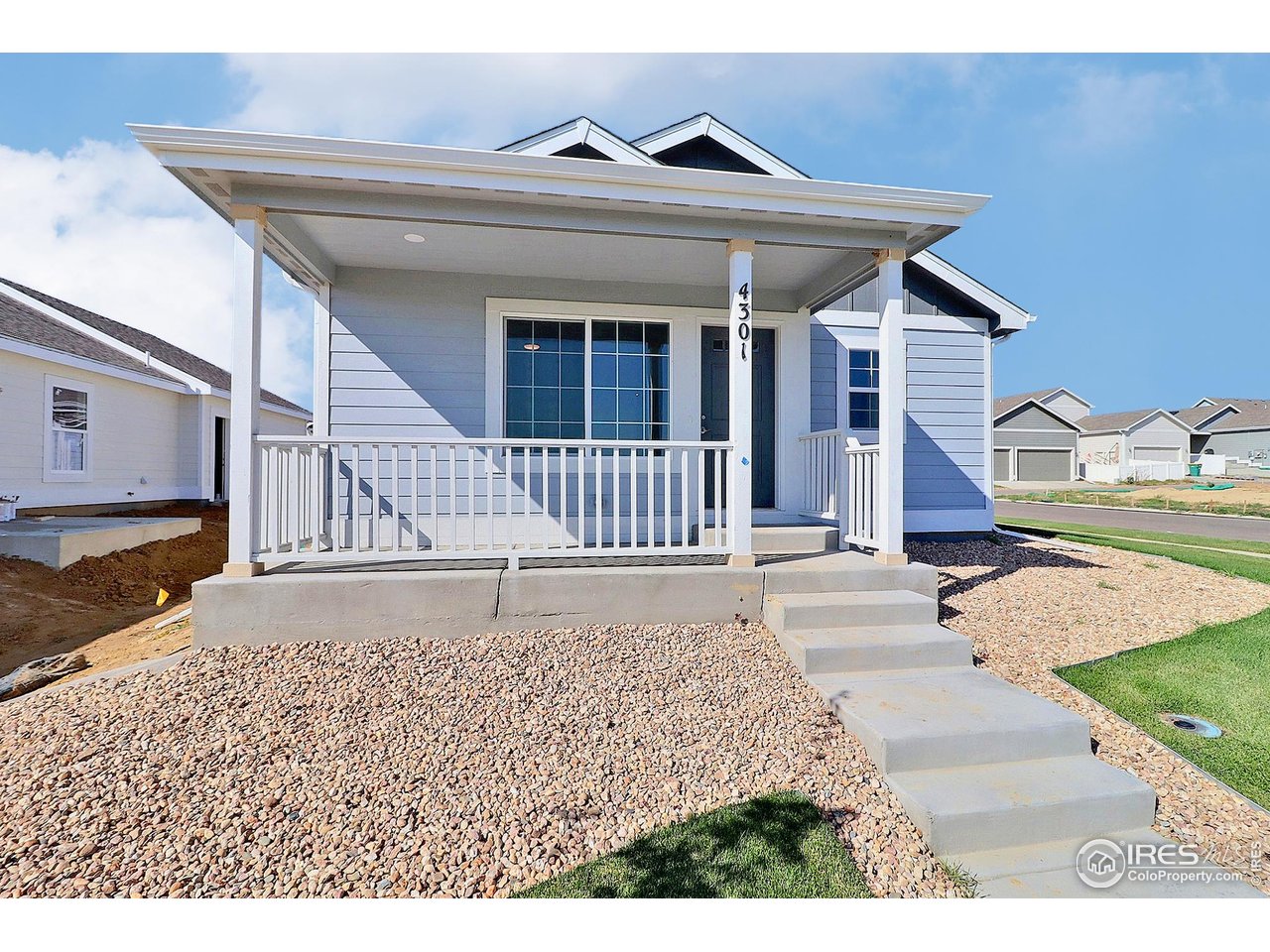 4301 Rockcress Road Evans, CO 80620 - Photo 3 of 26 a front view of a house with a yard and garage
