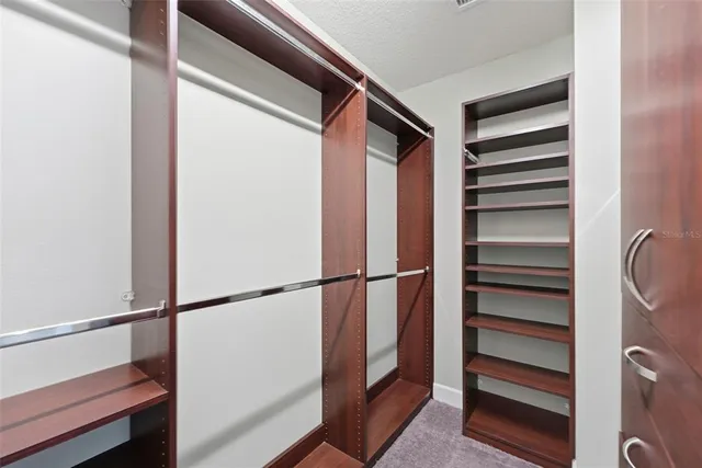 a bathroom with a granite countertop sink a bathtub a mirror a vanity and bathtub