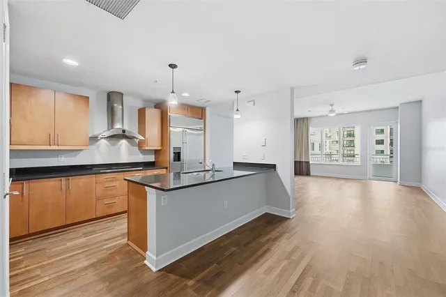 a kitchen with stainless steel appliances granite countertop a sink and a stove