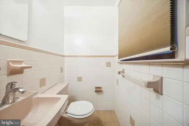 a white toilet sitting next to a bathroom sink