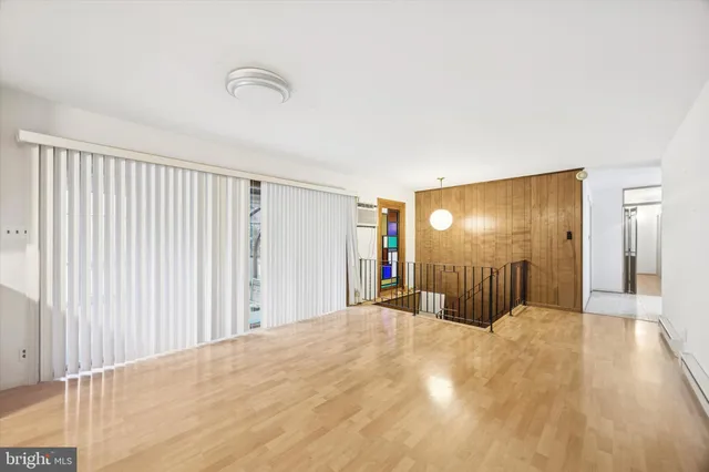 a view of a bedroom with a large bed and wooden floor
